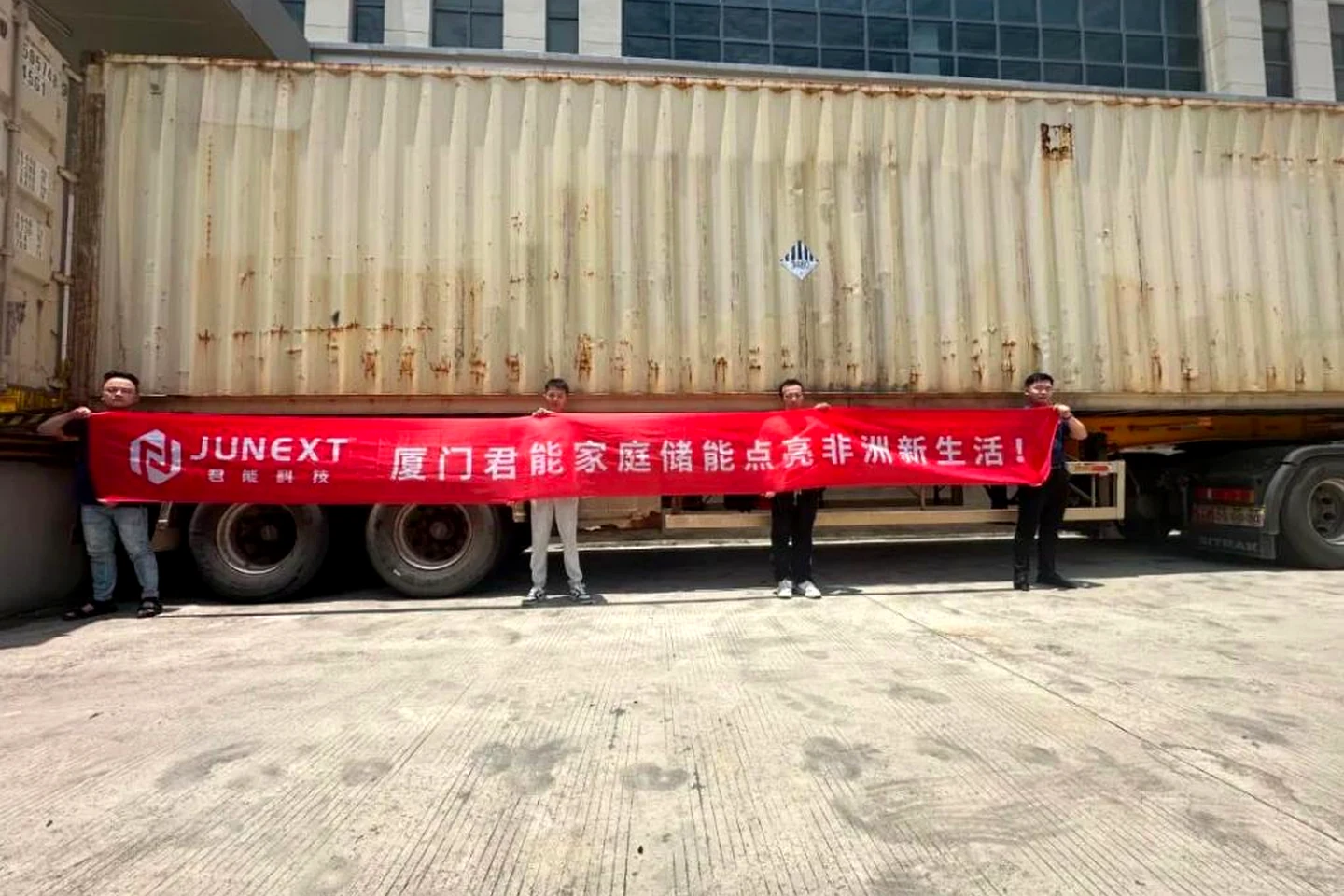 JUNEXT team beside the residential energy storage shipment container
